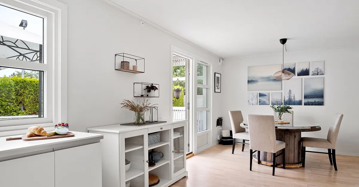 Bright white wall color paired with a light oak hardwood floor in a living space