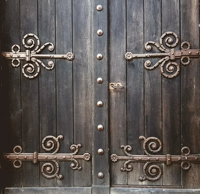 Wrought iron strap hinges on a plank wood door
