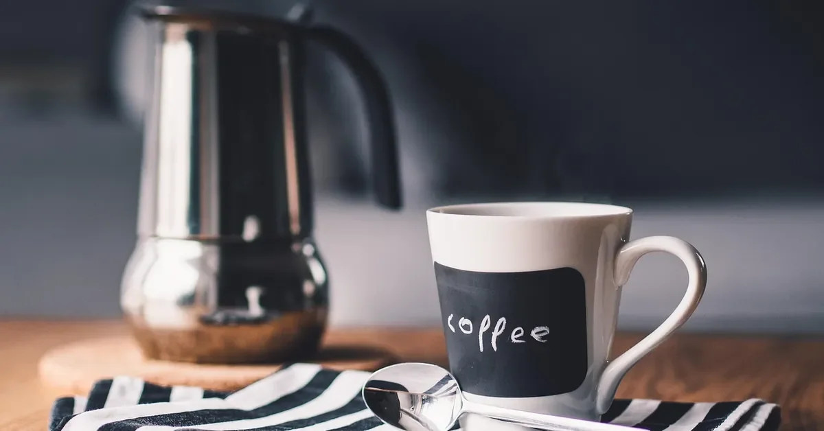 Coffee mug on a wooden table where hot or wet cups can leave white rings in the finish