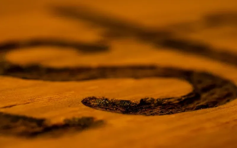 Close-up of marks on a glossy varnished wood surface