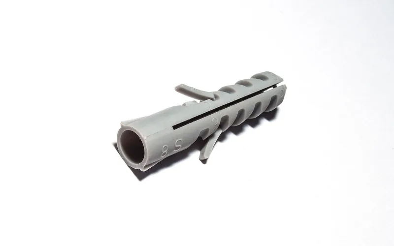 Ribbed gray plastic expansion plug used as a wall anchor Ribbed gray plastic expansion plug used as a wall anchor