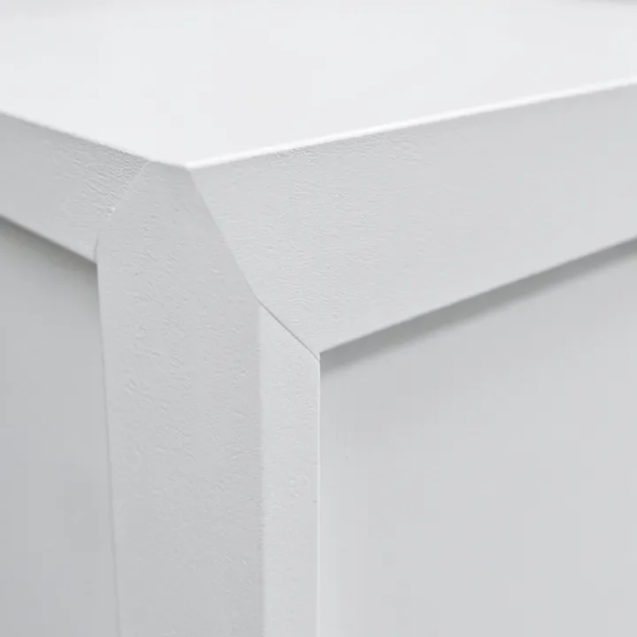 Close-up of a painted MDF cabinet door edge profile showing the smooth factory-sealed finish