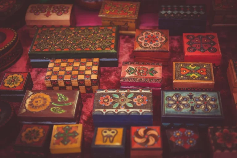 Collection of decorated wooden boxes with various paint and stencil designs