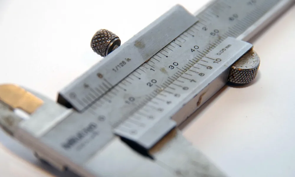 Vernier caliper used to check real plywood thickness before cutting divider slots