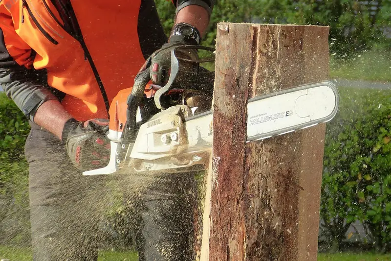 Chainsaw cutting into a wooden post with sawdust flying and the bar tip clear of the wood