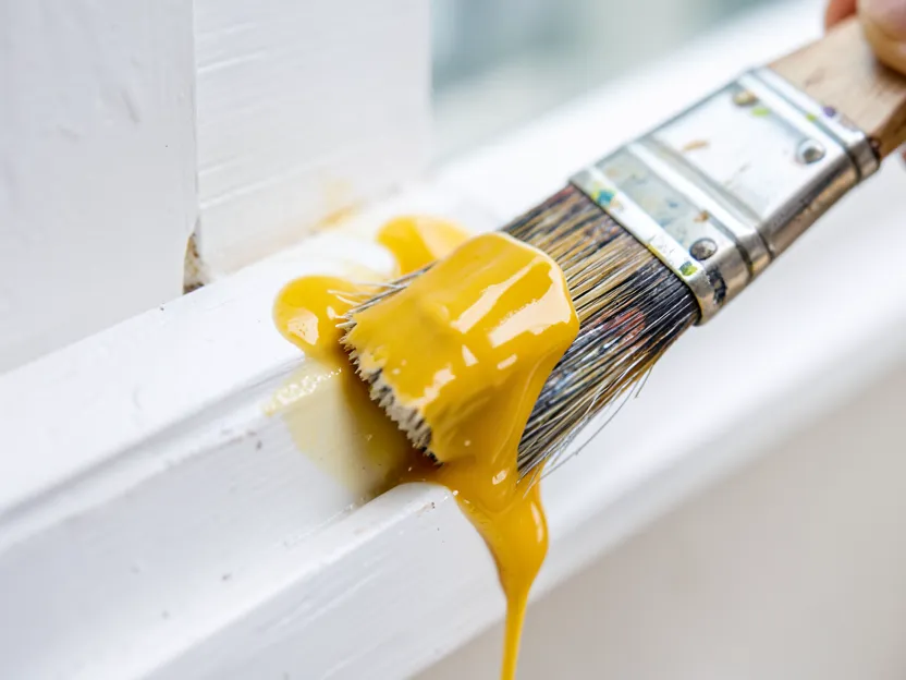Citrus-based paint stripping gel being brushed onto a painted wood trim
