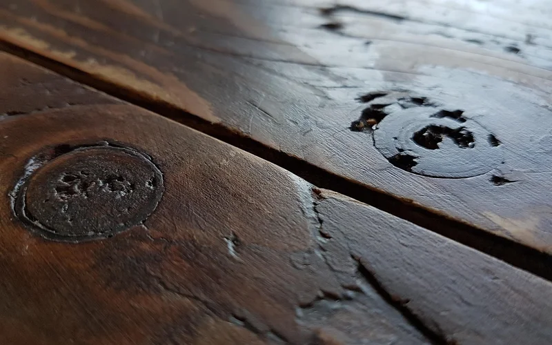 Dark stained hardwood flooring, close-up grain detail
