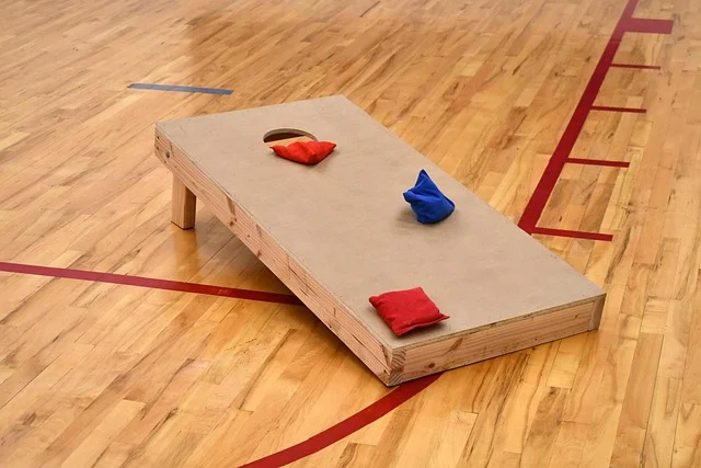 Finished DIY cornhole board with red and blue bean bags