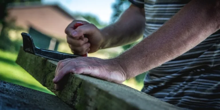 Man using a hand plane to smooth a wood board for a beginner DIY project