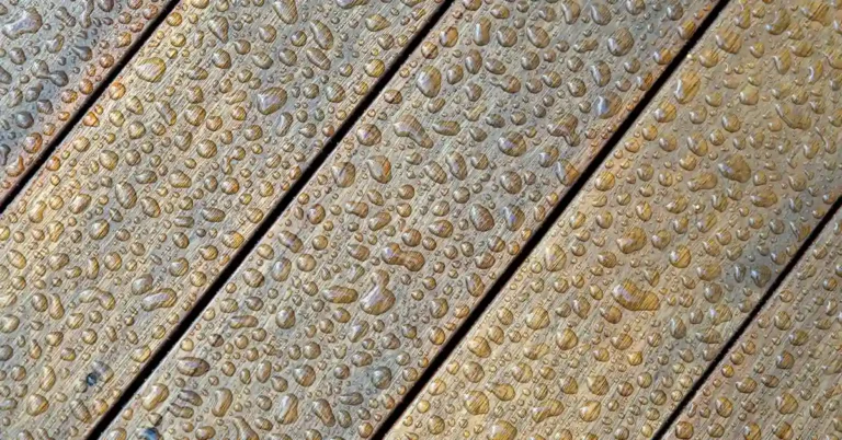 water droplets beaded on the surface of engineered hardwood floor boards
