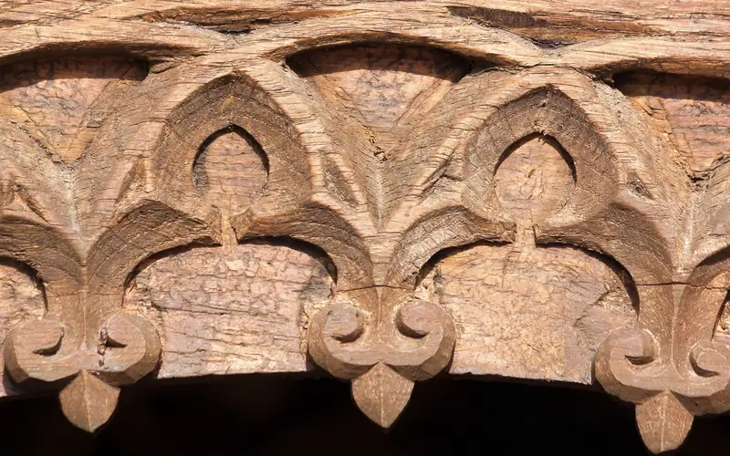 hand-carved wooden door panel with detailed relief carving