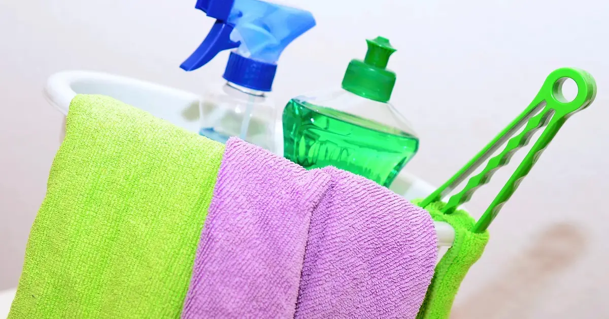 Cleaning supplies including dish soap and cloths used to remove marker stains from wood