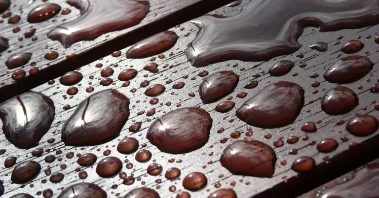 Water beading on a lacquer-finished wood surface rather than soaking in