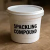 Lightweight spackling compound with primer