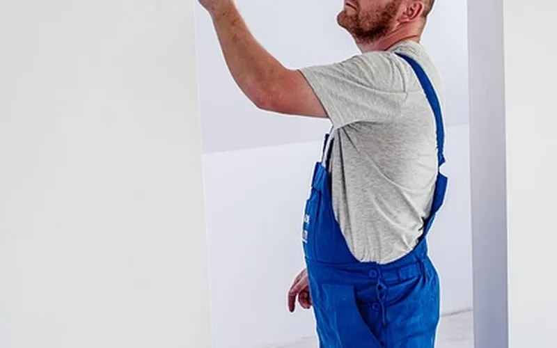 Professional painter refinishing a surface with a paint roller