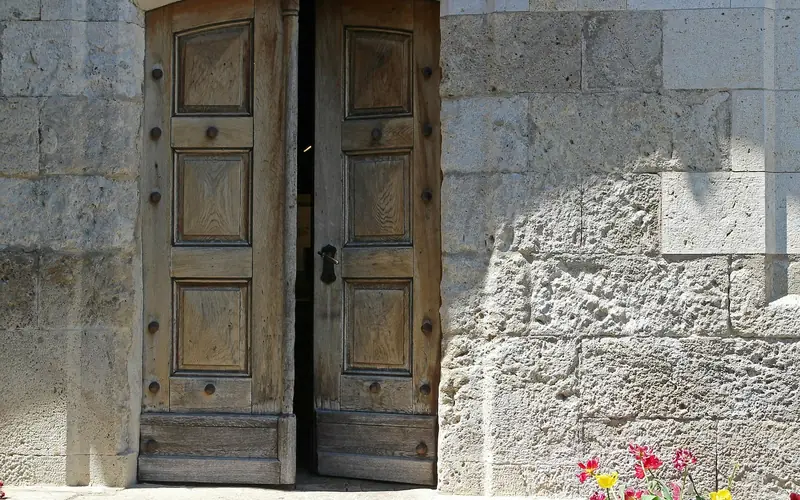 natural wood entrance door set into an exterior house facade