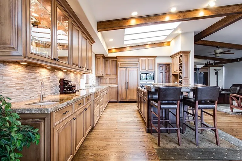 Warm wood-toned kitchen cabinets and drawers with visible grain, similar to teak cabinetry