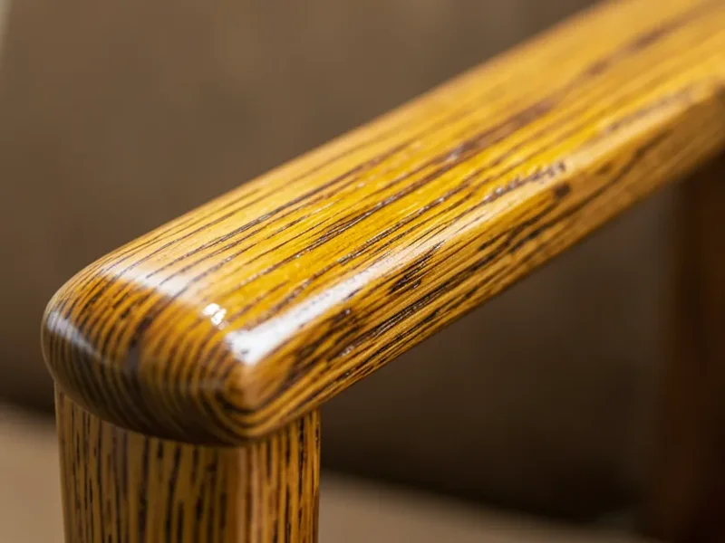 Close-up of natural teak wood grain on a chair armrest