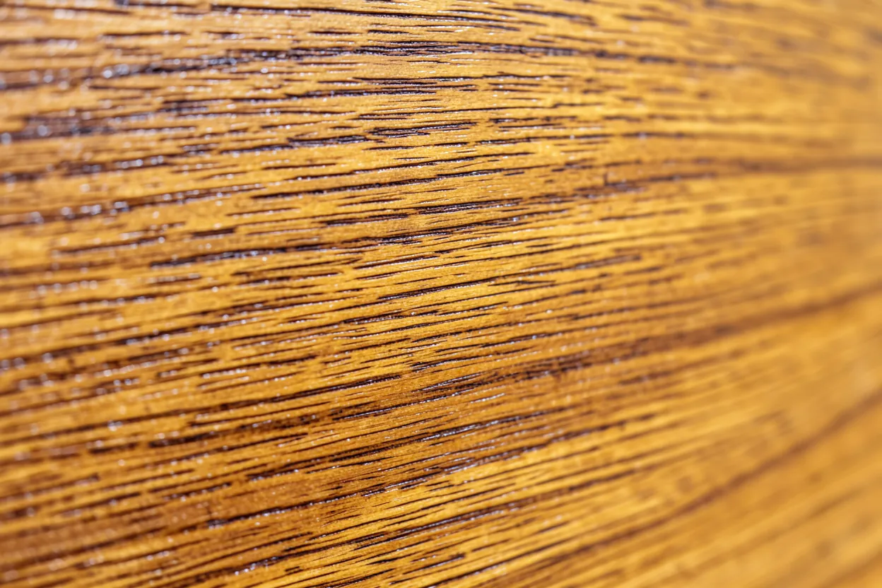 Close-up of natural teak wood grain texture used as a modern interior wall panel