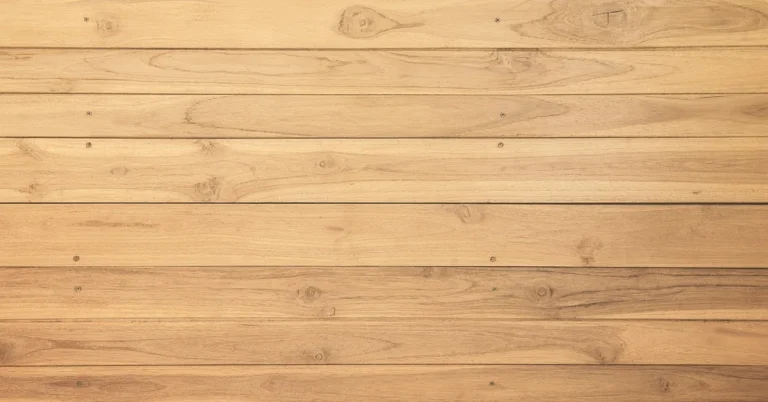 Warm golden teak wood wall panels with visible grain and knots