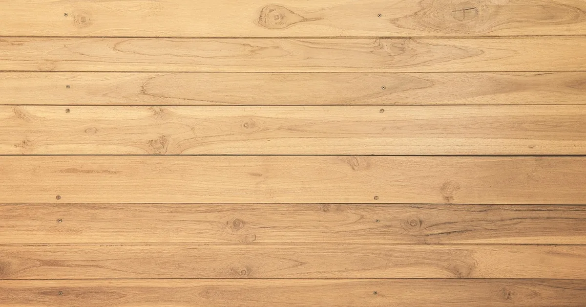 Warm golden teak wood wall panels with visible grain and knots