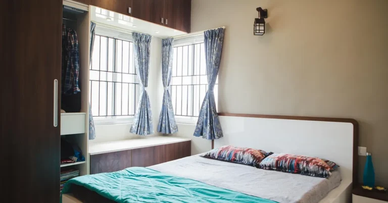 Teak wood wardrobe with sliding doors in a modern bedroom