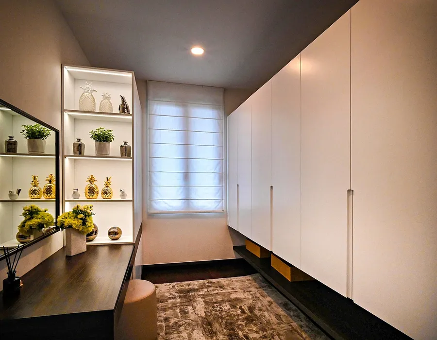 Teak wood wardrobe built along one wall in a small bedroom