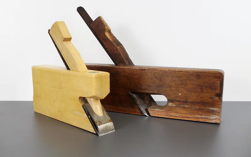 Wood hand planes and veneer repair tools on a workbench
