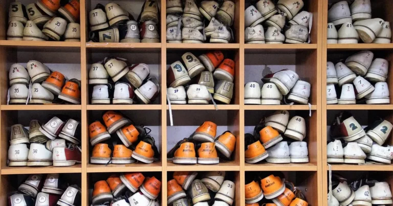 Wooden shelving units holding many pairs of shoes