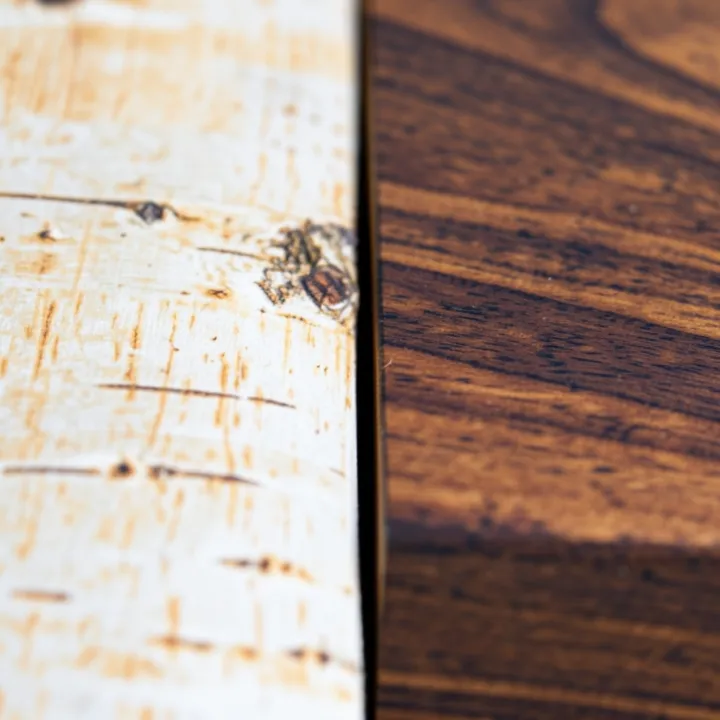 Close-up comparison of birch wood grain next to walnut wood grain