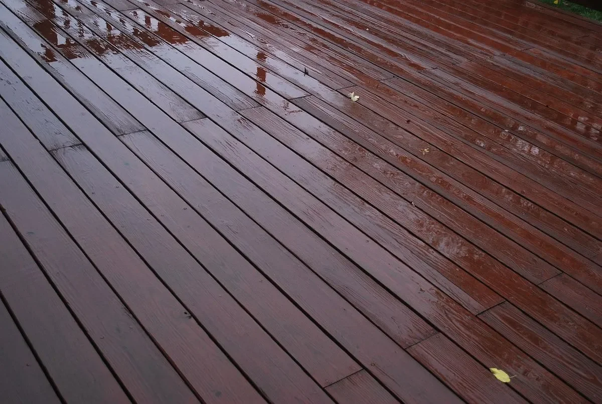 Freshly finished reddish-brown wood deck boards