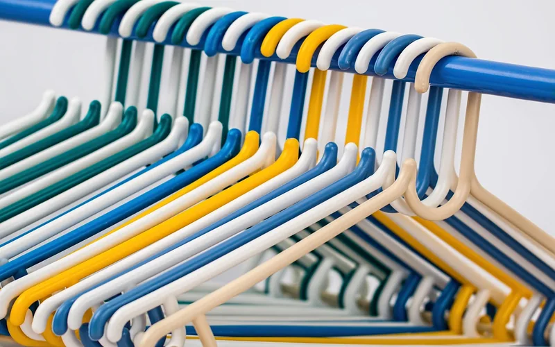 clothes hangers on a closet rod colorful plastic clothes hangers hanging closely together on a closet rod