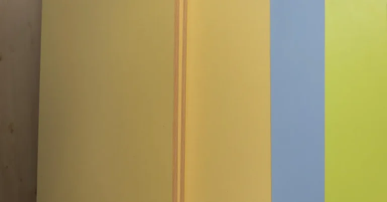 Stack of colored MDF panels displayed at a hardware store, showing the flat smooth cut edge typical of medium-density fi