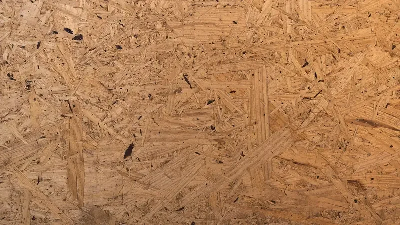 close up of oriented strand board surface showing large wood strands