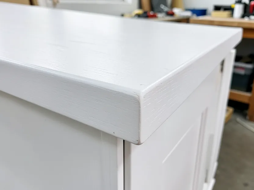 Close-up of a smooth white-painted poplar wood cabinet corner