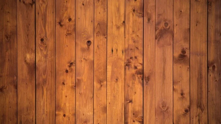 Vertical pine plank wall showing the board-and-seam look of shiplap-style paneling