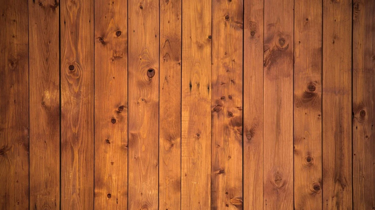 Vertical pine plank wall showing the board-and-seam look of shiplap-style paneling