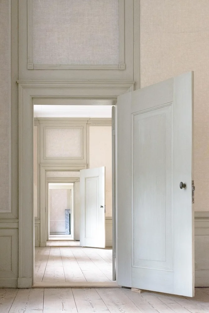Painted wainscoting panels on the lower half of a wall in a bright room