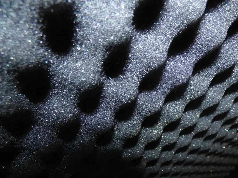 Close-up of dark open-cell acoustic foam with an egg-crate surface