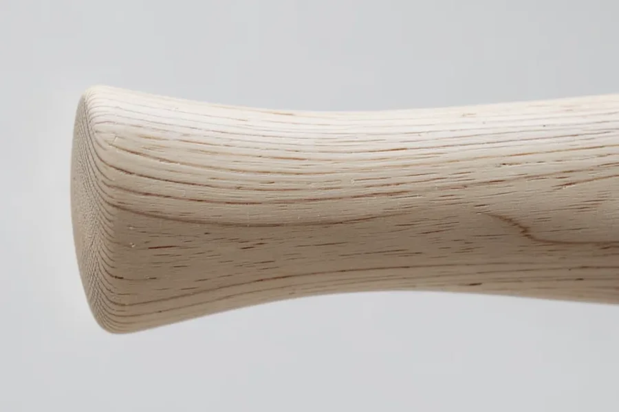Close-up of an ash wood axe handle showing straight grain