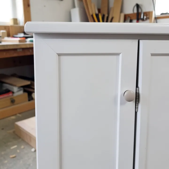 Close-up of a smooth white-painted shaker-style cabinet door