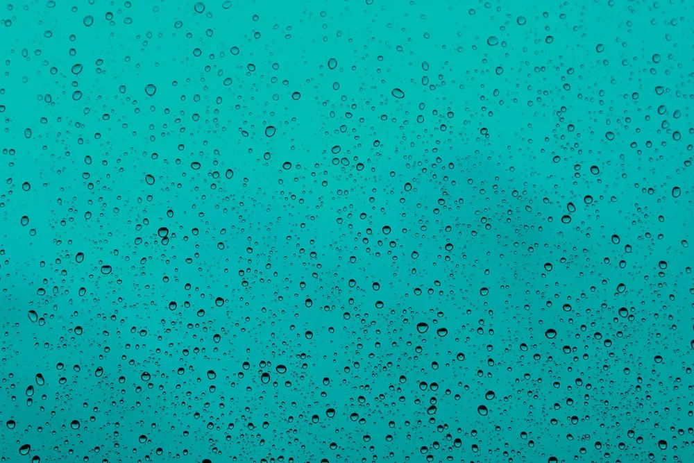 Condensation droplets covering a cold glass surface, showing how moisture forms on cold surfaces