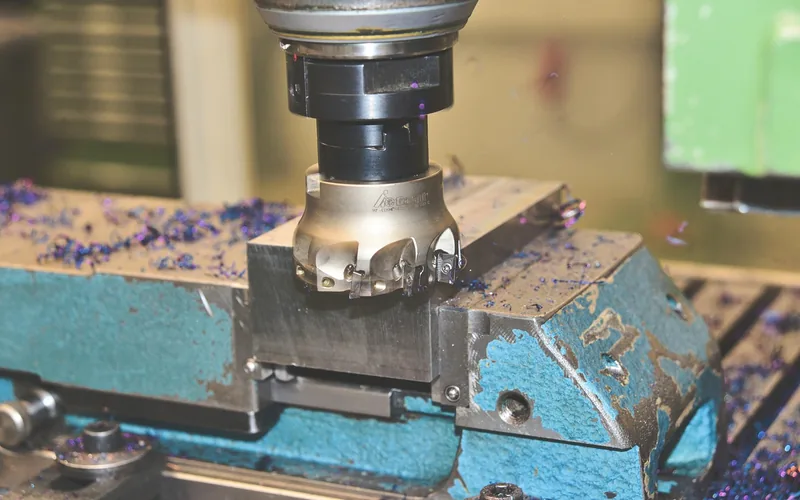 Close-up of small square carbide inserts mounted in a staggered pattern on a cutterhead
