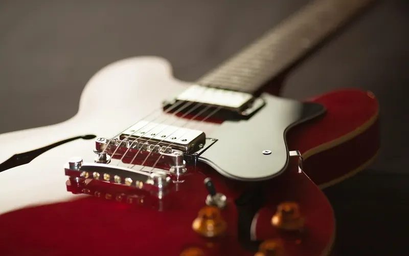 Close-up of an electric guitar body, bridge and pickups Close-up of an electric guitar body, bridge and pickups