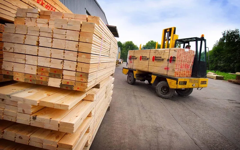 Forklift loading stacked lumber for delivery from a supply yard Forklift loading stacked lumber for delivery from a supply yard