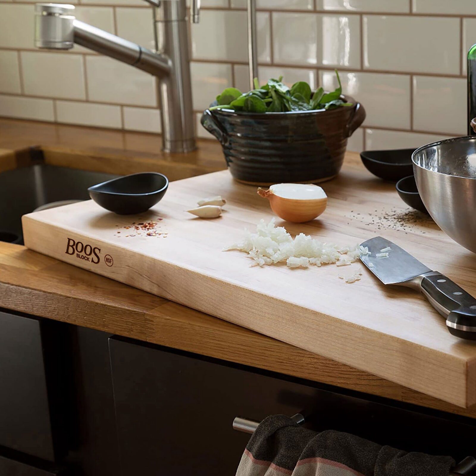 John Boos reversible maple wood cutting board on kitchen counter