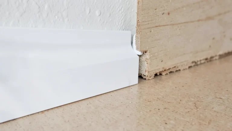 Raw MDF baseboard next to a painted section showing why paint is the practical finish