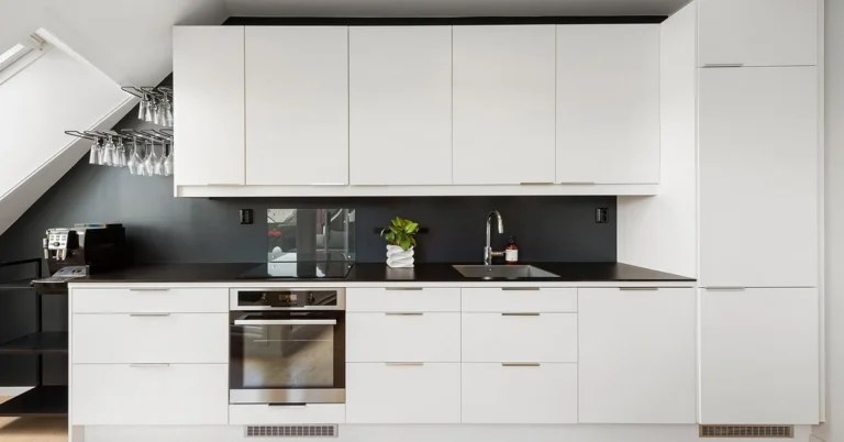 White MDF kitchen cabinets with flat panel doors in a modern kitchen