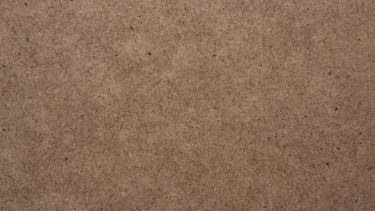 Close-up of the surface of a brown fiberboard panel used for MDF and hardboard