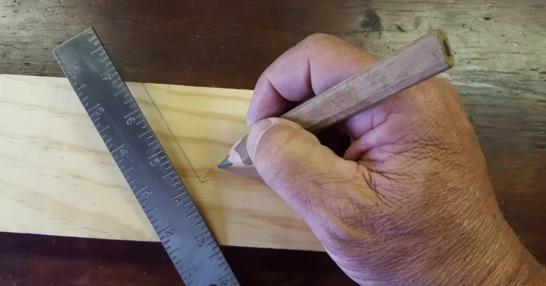 carpenter measuring and marking a wood board with a ruler and pencil before a repair
